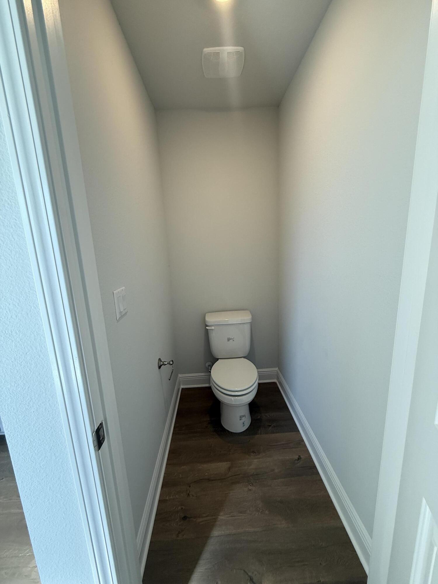 6013 Crocket Cove Crestview, FL 32539 - Photo 24 of 27 a white toilet sitting next to a small sink