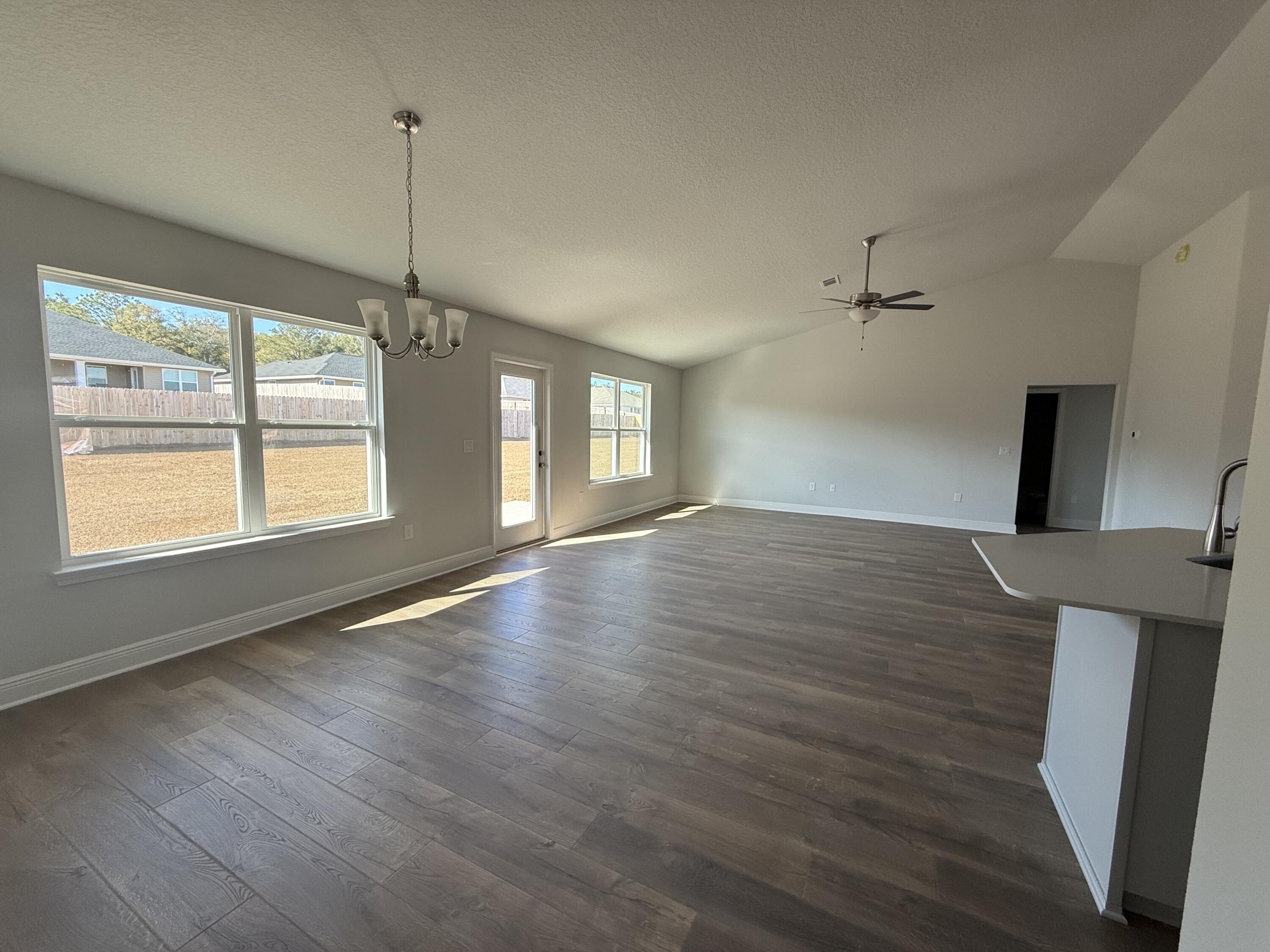 6013 Crocket Cove Crestview, FL 32539 - Photo 26 of 27 a view of an empty room with window and wooden floor