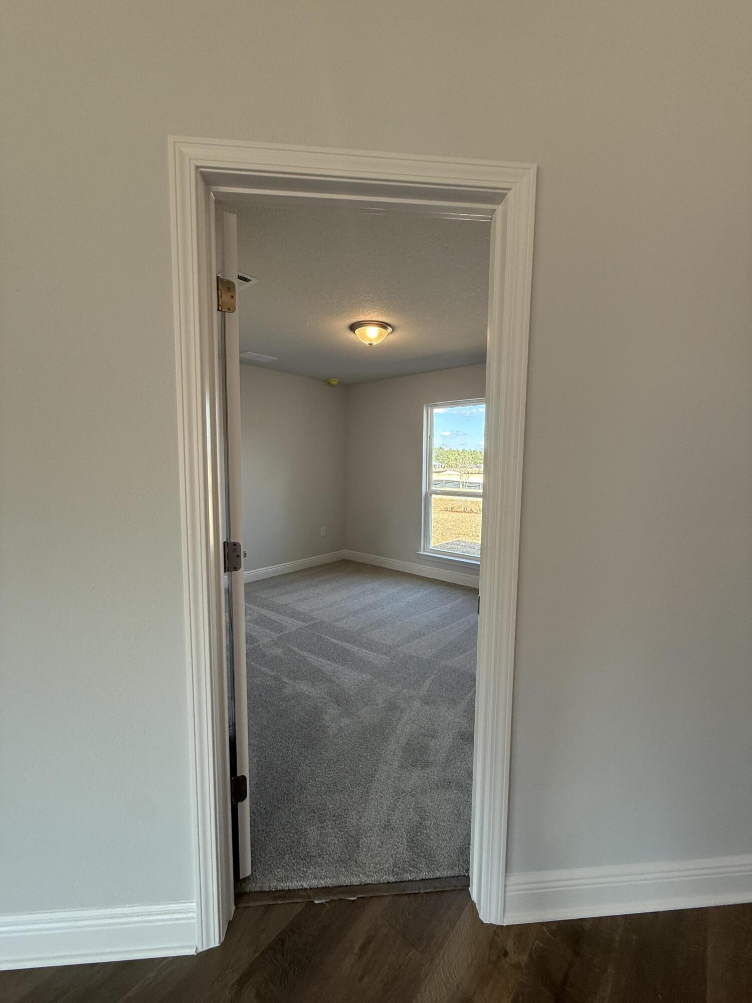 6013 Crocket Cove Crestview, FL 32539 - Photo 7 of 27 a view of an empty room with closet and a window