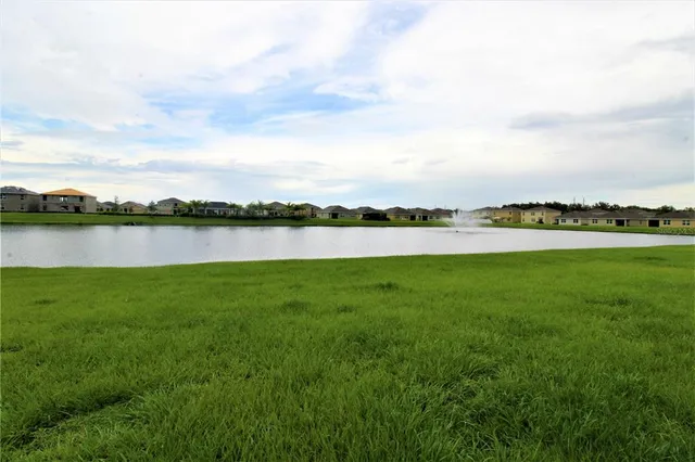 a view of a lake with houses in the back