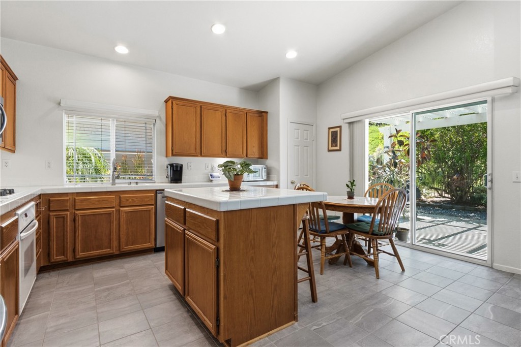 33145 Vermont Road Temecula, CA 92592 - Photo 16 of 41 a kitchen with a sink and wooden cabinets