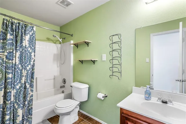 a bathroom with a sink mirror and toilet
