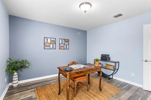 a workspace room with furniture and wooden floor