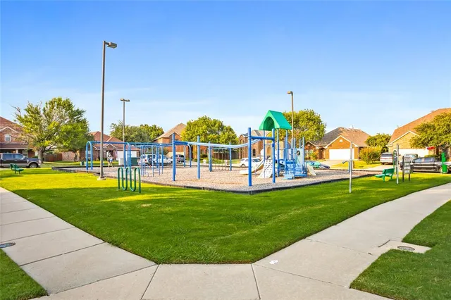 an aerial view of a house with a yard and lake view