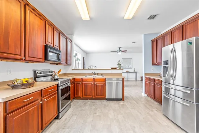a kitchen with stainless steel appliances granite countertop a sink and cabinets