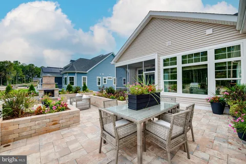 a view of a house with backyard and sitting area
