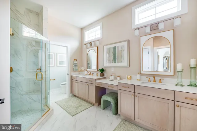 a bathroom with a double vanity sink mirror and shower