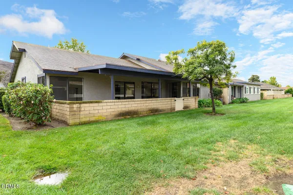 a view of a house with a backyard