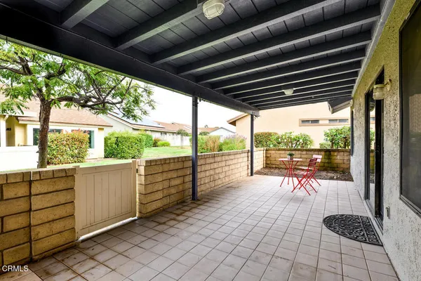 a view of a porch with furniture and wooden floor