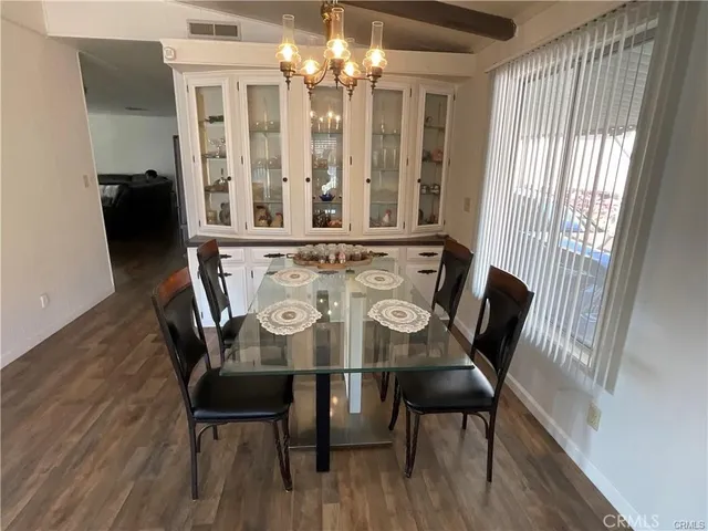 a view of a dining room with furniture and window
