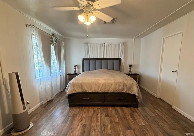 a bed sitting in a room next to a window