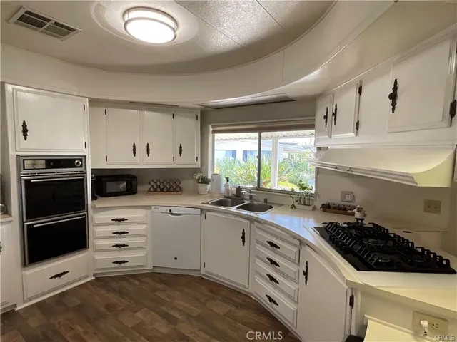 a kitchen with a sink stove and cabinets