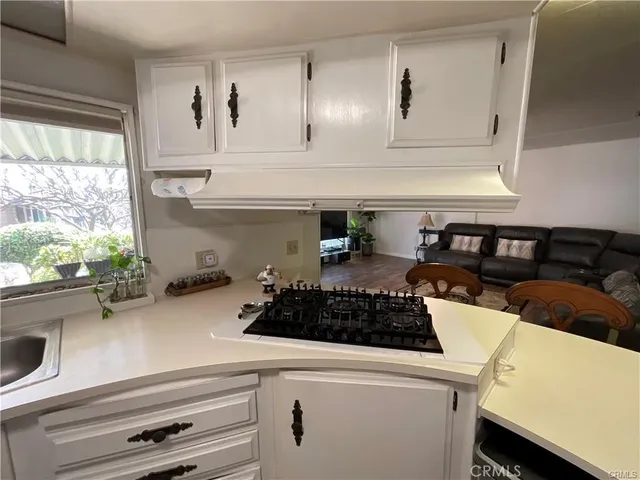 a kitchen with a stove and a white cabinets