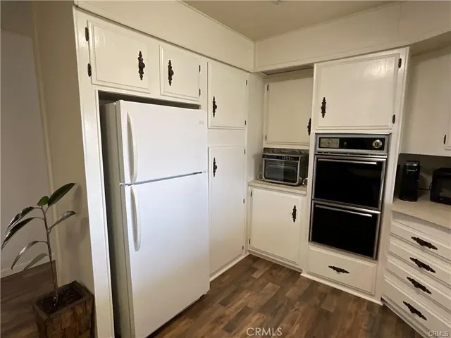 a kitchen with stainless steel appliances a refrigerator and a stove top oven