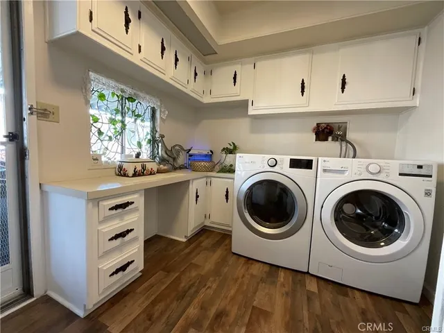 a view of cabinets a washer and dryer