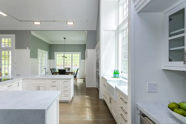a large white kitchen with a window