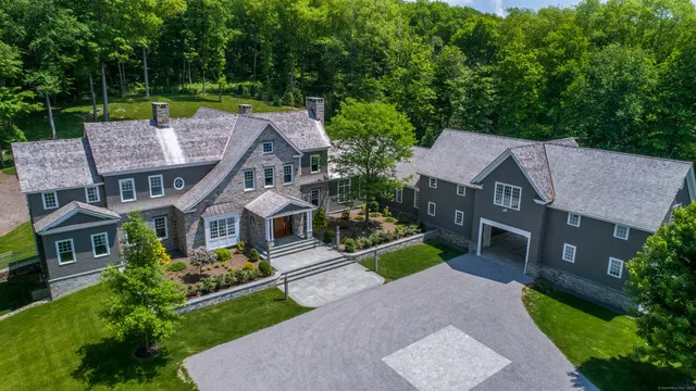 an aerial view of a house with a yard table and chairs