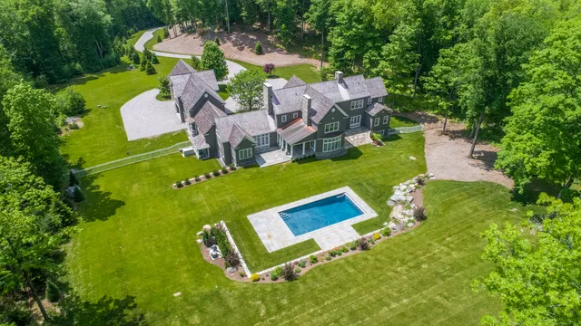 an aerial view of a house with outdoor space pool seating area and yard