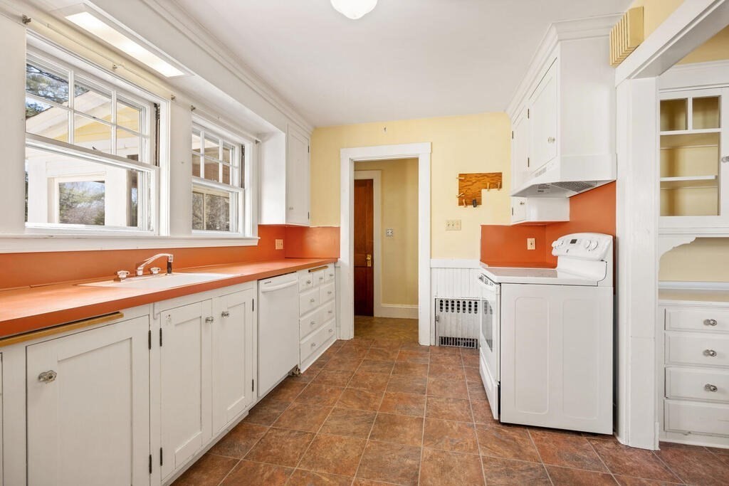 8 Spring Street Lexington, MA 02421 - Photo 19 of 35 a utility room with cabinets washer and dryer