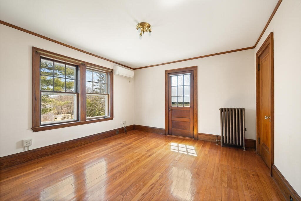 8 Spring Street Lexington, MA 02421 - Photo 21 of 35 an empty room with wooden floor and windows
