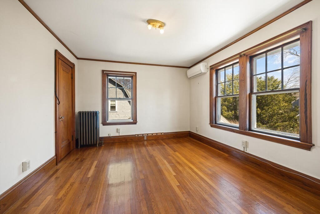 8 Spring Street Lexington, MA 02421 - Photo 23 of 35 an empty room with wooden floor and windows