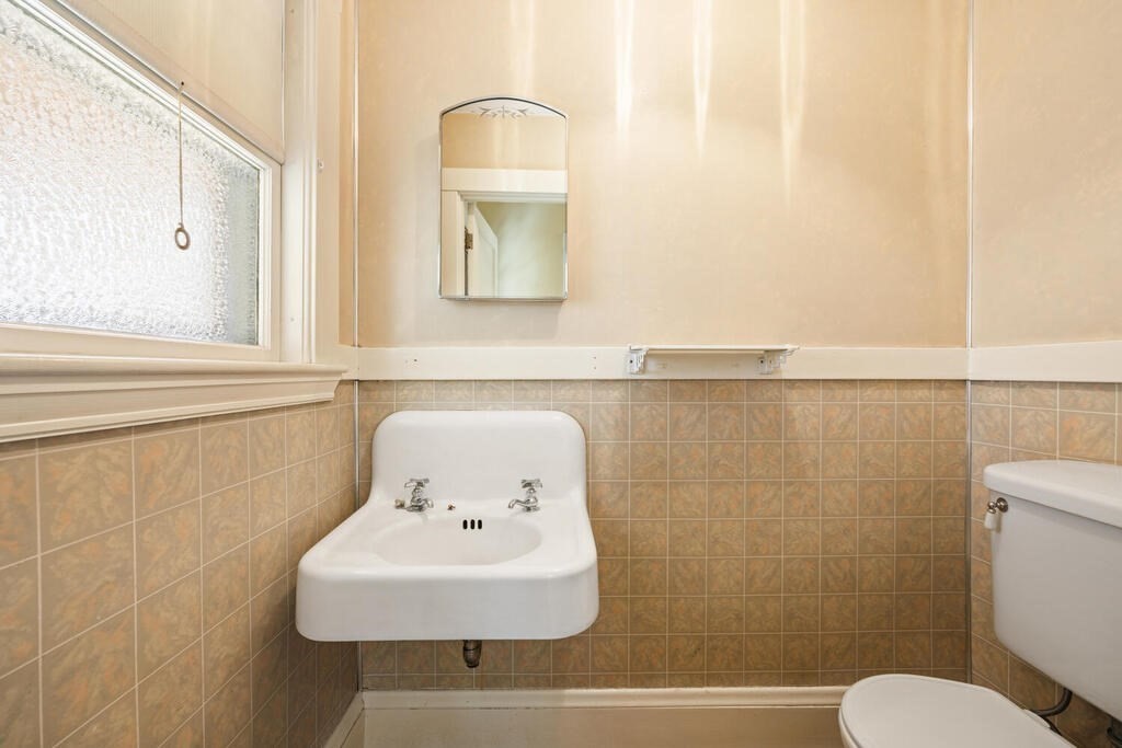 8 Spring Street Lexington, MA 02421 - Photo 27 of 35 a bathroom with a sink mirror and toilet