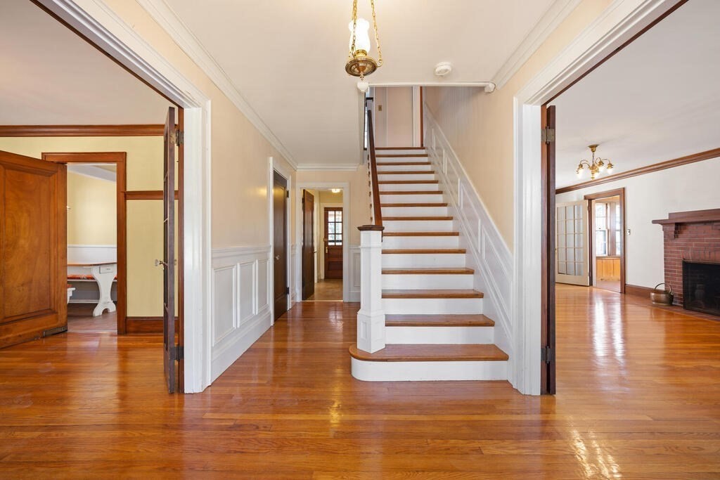 8 Spring Street Lexington, MA 02421 - Photo 6 of 35 a view of a hallway with wooden floor and staircase