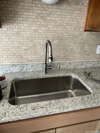 a bathroom with a sink and granite