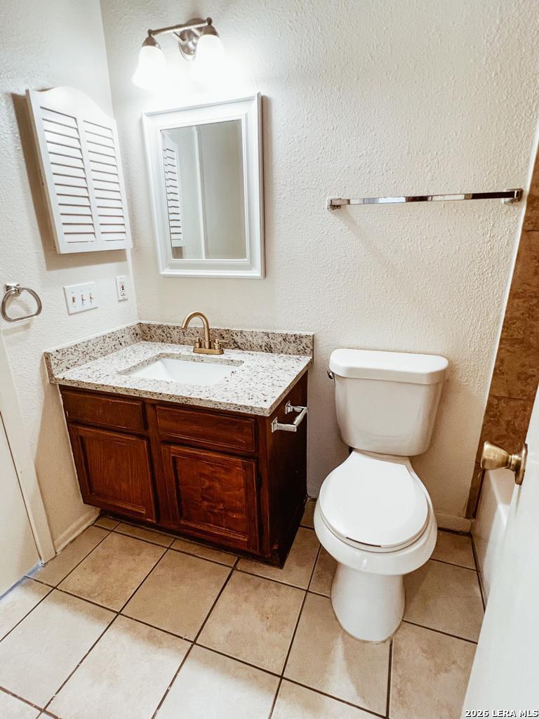 5562 Rangeland San Antonio, TX 78247 - Photo 5 of 9 a bathroom with a toilet sink and mirror