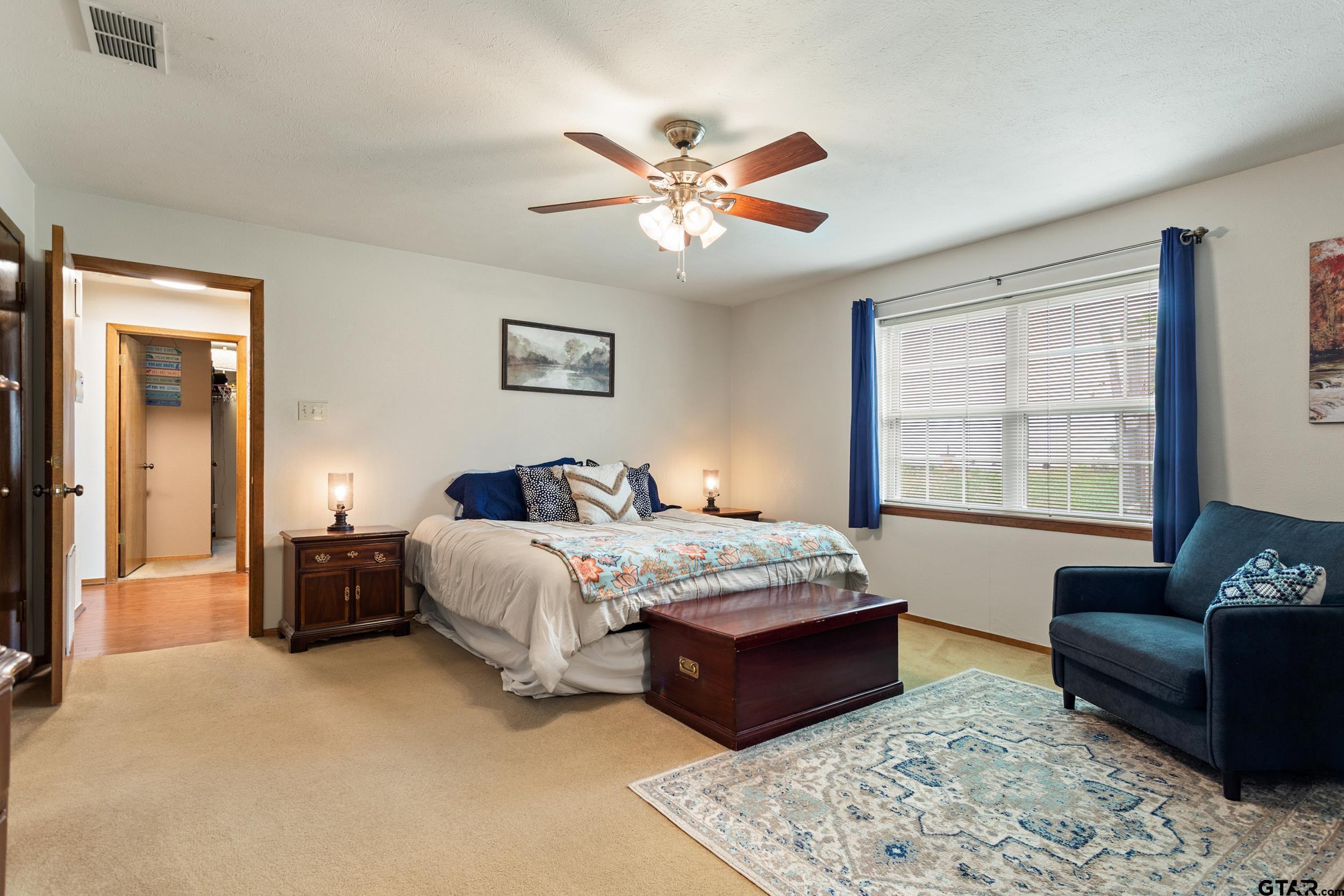 516 Ruthlynn Drive Longview, TX 75605 - Photo 18 of 34 a bedroom with a bed and a couch