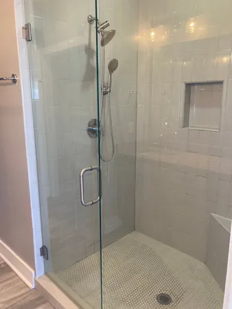 a bathroom with a glass shower door