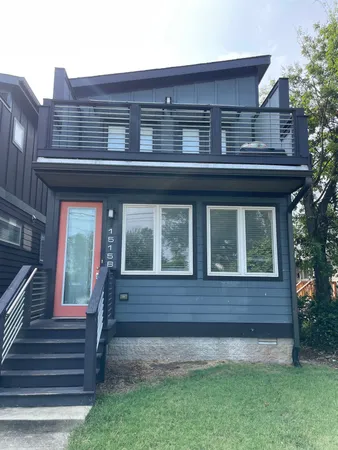 a view of house with a yard