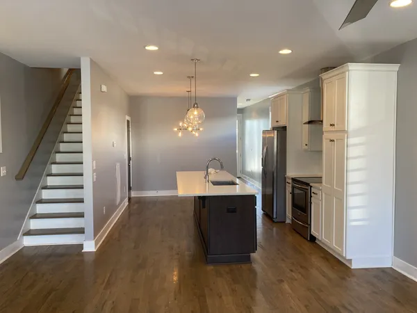 a view of kitchen with sink microwave and refrigerator