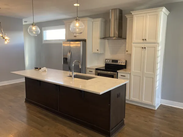 a kitchen with a sink and a refrigerator