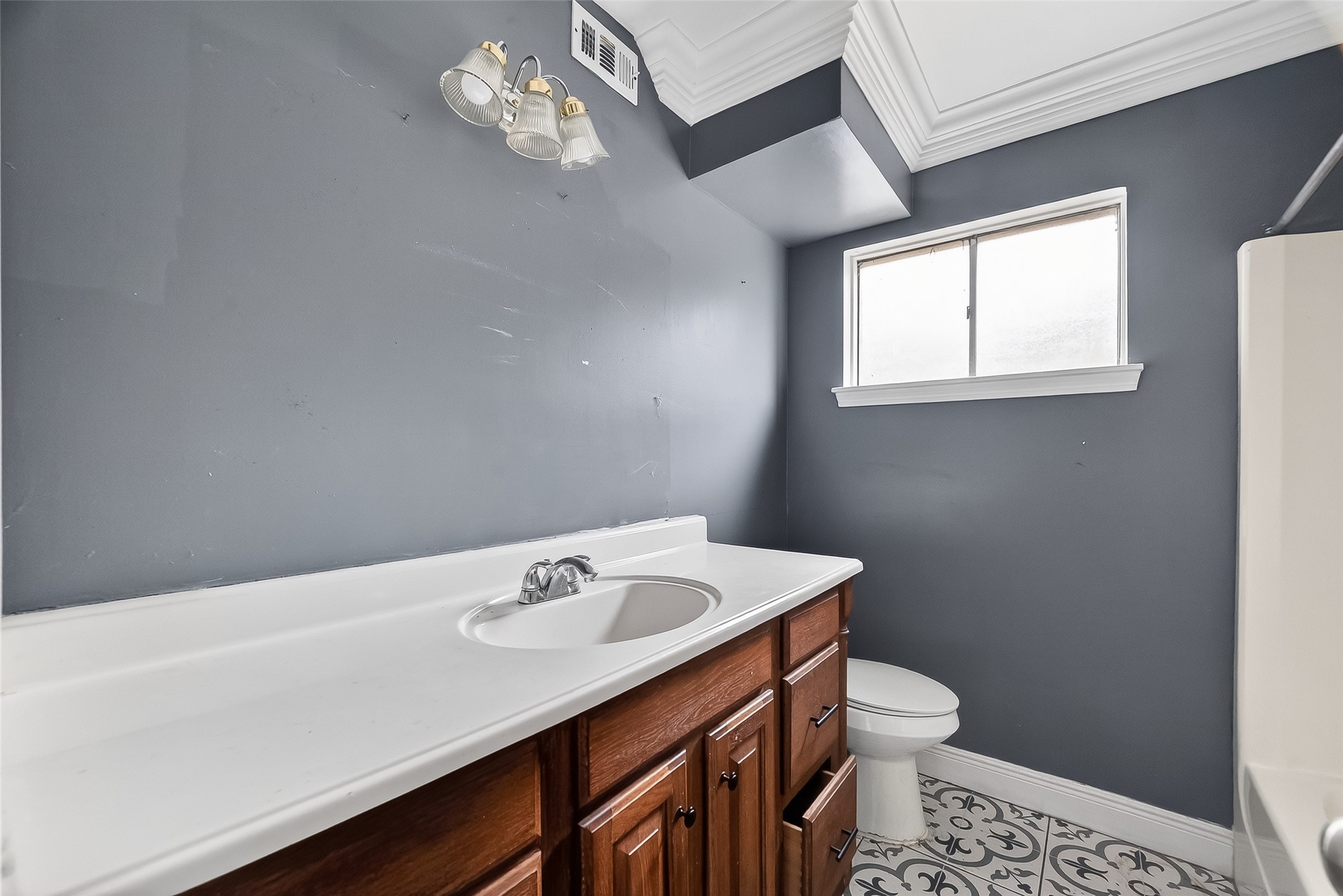 8438 Gallahad Street Houston, TX 77078 - Photo 18 of 36 a bathroom with a sink a toilet and a window