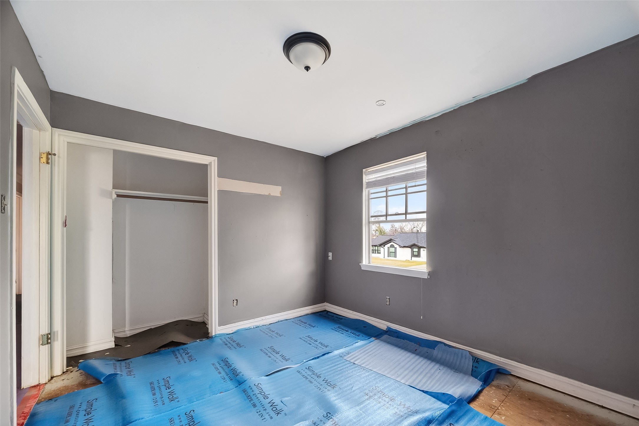 8438 Gallahad Street Houston, TX 77078 - Photo 24 of 36 an empty room with wooden floor and windows