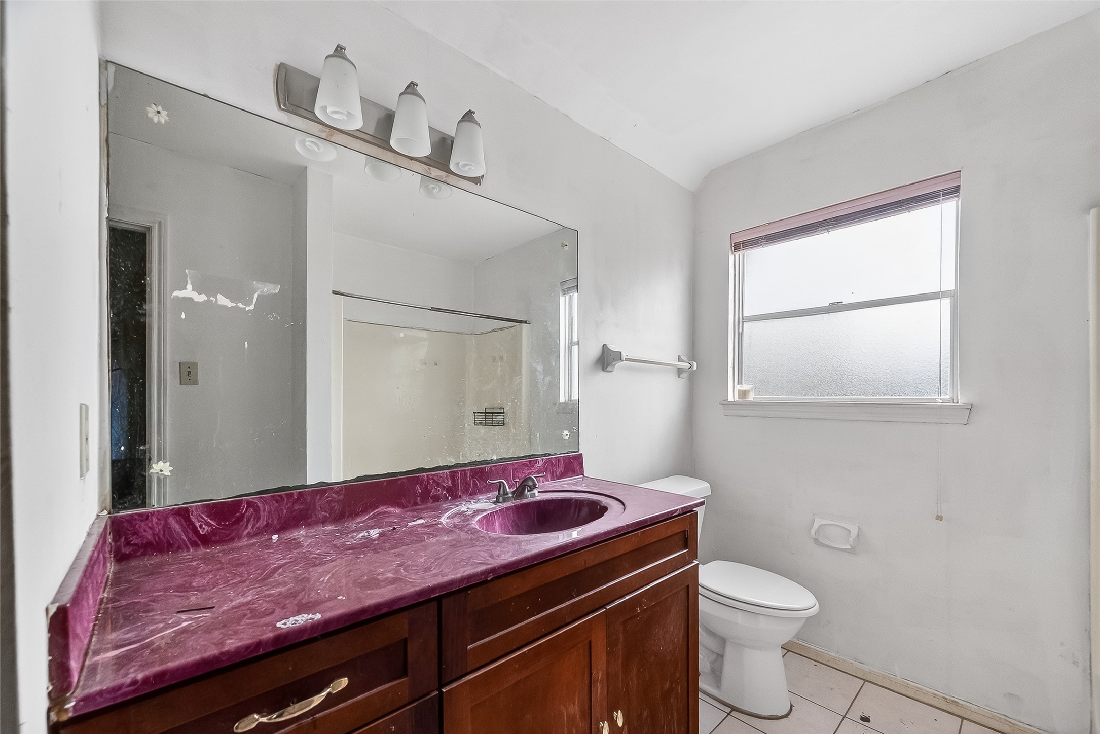 8438 Gallahad Street Houston, TX 77078 - Photo 29 of 36 a bathroom with a granite countertop sink a toilet and mirror
