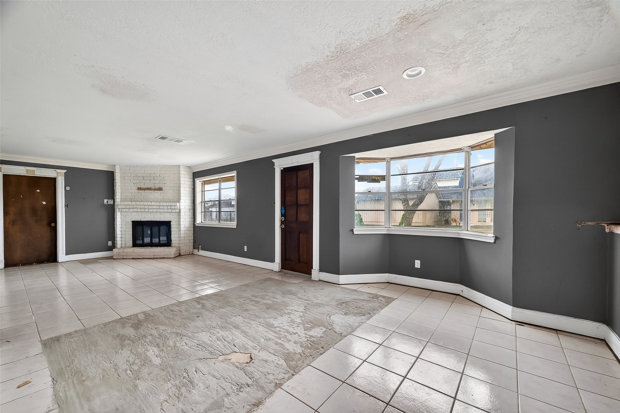 8438 Gallahad Street Houston, TX 77078 - Photo 8 of 36 a view of an empty room with a fireplace and a window