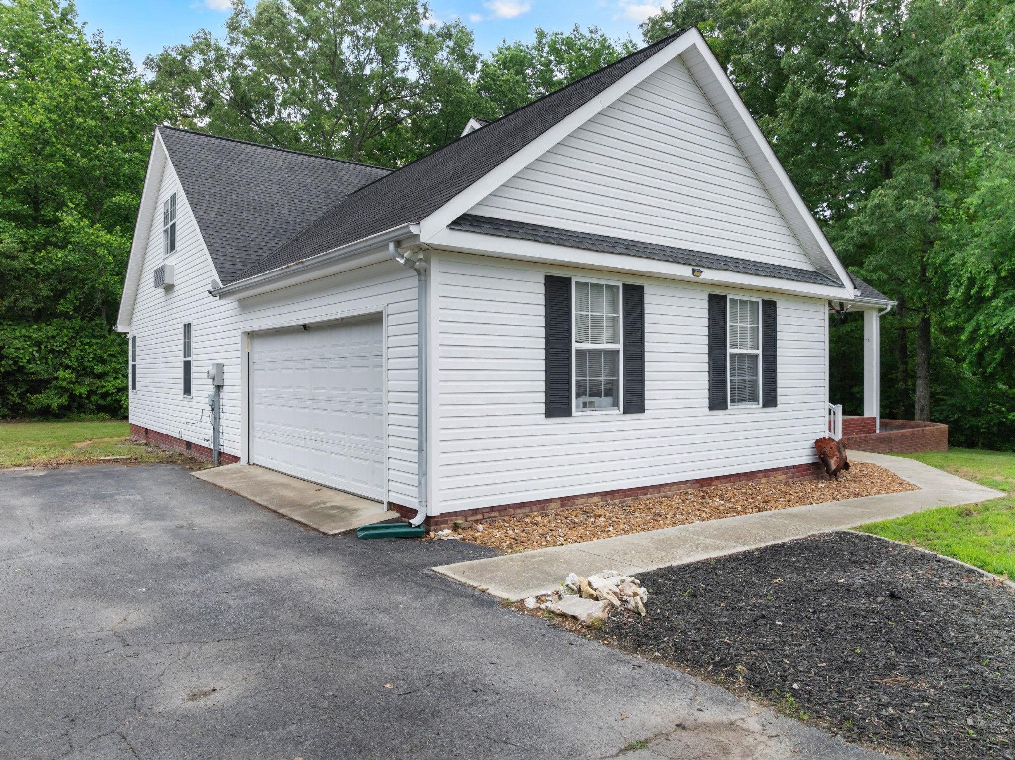 71 Larkspur Court Tullahoma, TN 37388 - Photo 29 of 31 a view of a small white house with a small yard and large tree