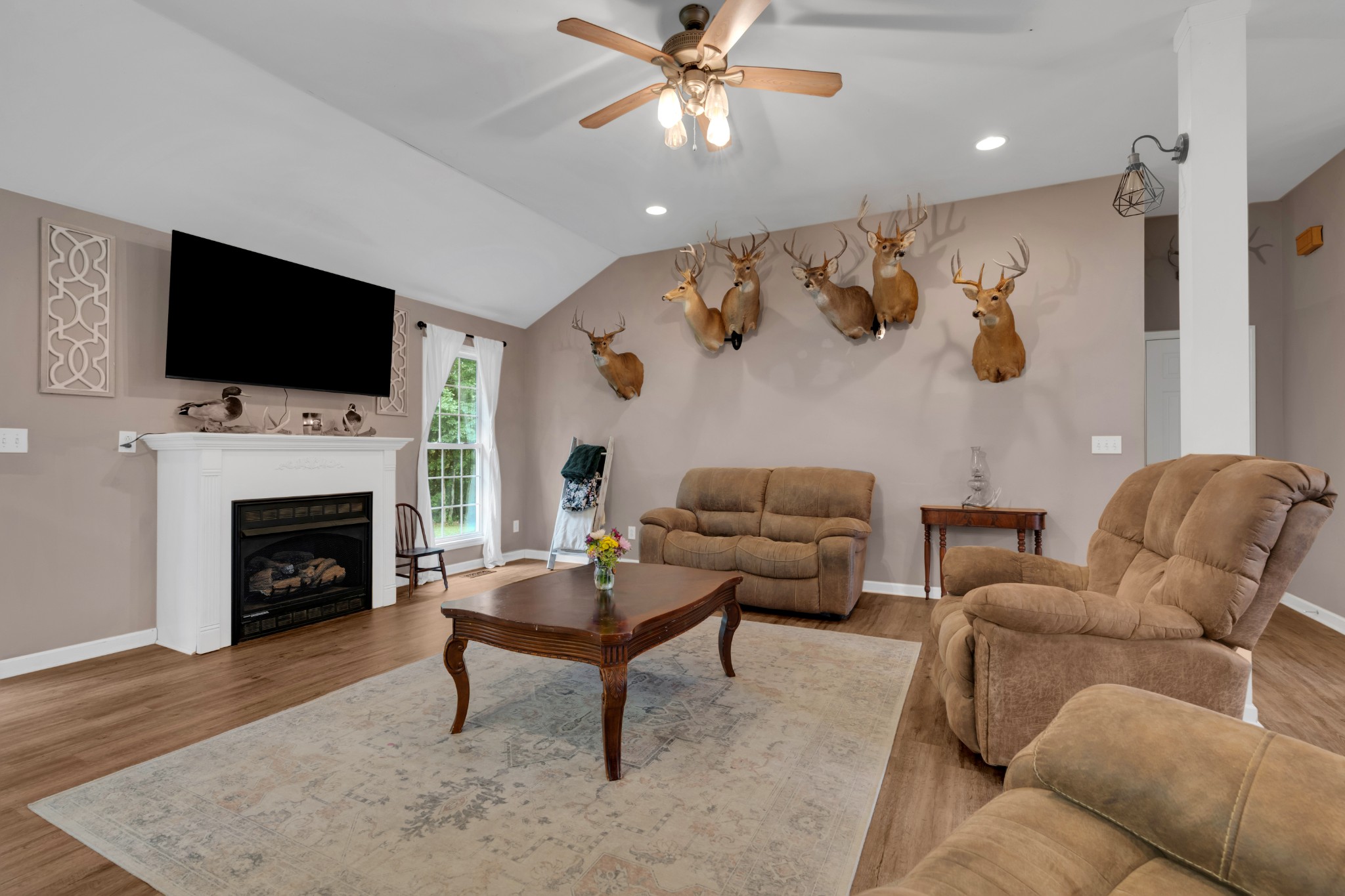 71 Larkspur Court Tullahoma, TN 37388 - Photo 7 of 31 a living room with furniture a flat screen tv and a fireplace