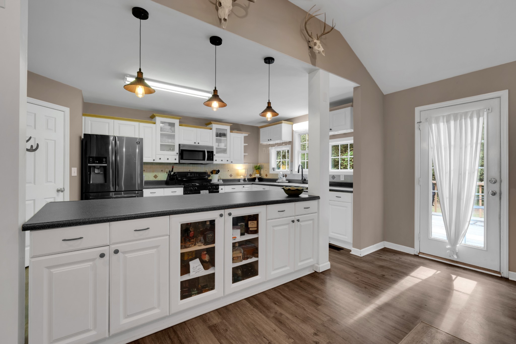 71 Larkspur Court Tullahoma, TN 37388 - Photo 10 of 31 a kitchen with stainless steel appliances granite countertop a refrigerator a sink dishwasher a stove and white cabinets with wooden floor