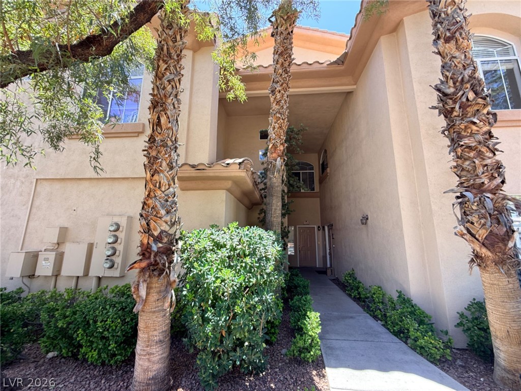 2050 West Warm Springs Road, Unit 3521 Henderson, NV 89014 - Photo 2 of 12 A welcoming entryway nestled between lush palm trees and verdant landscaping.