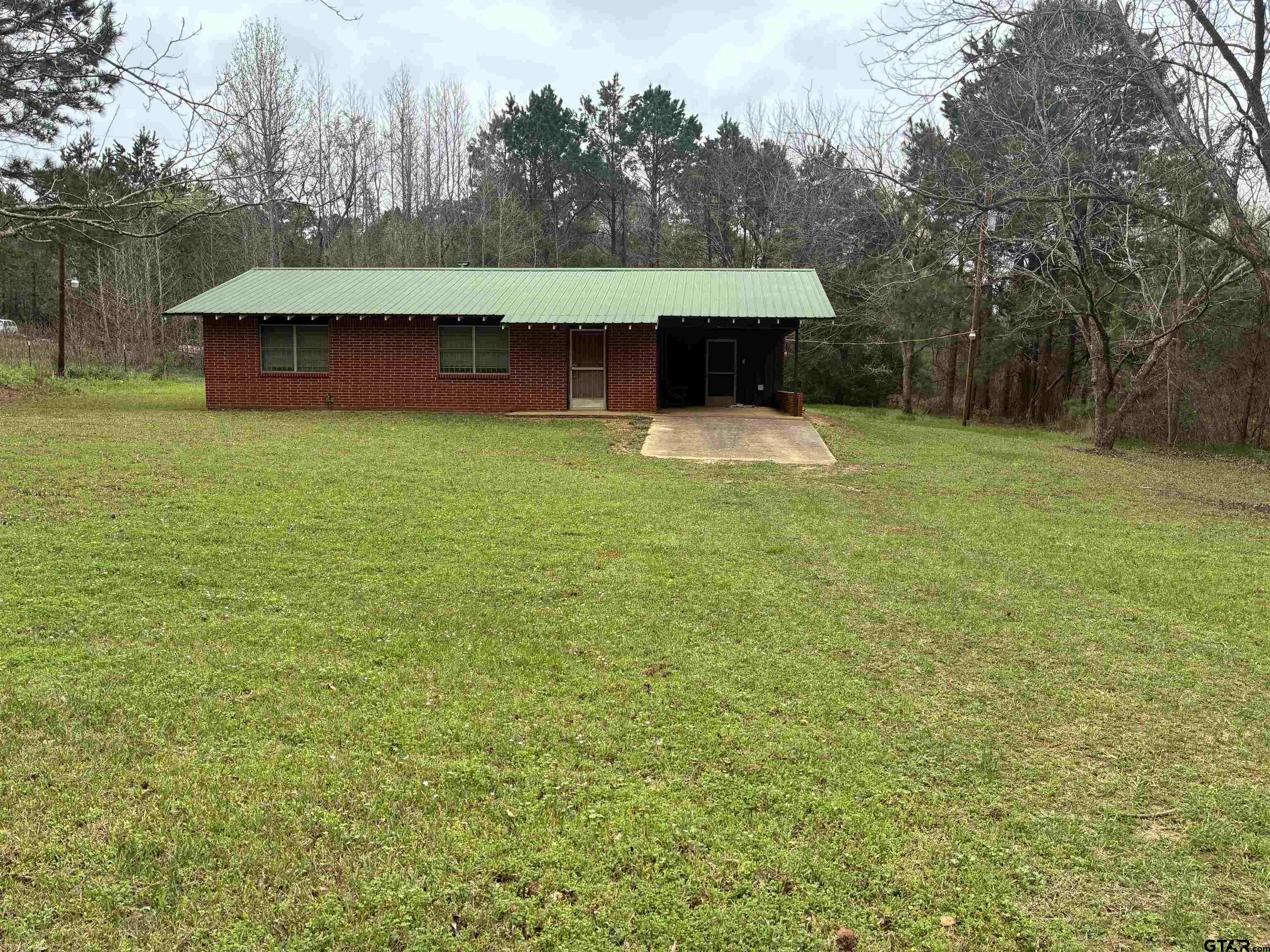 683 County Road 1209 Rusk, TX 75785 - Photo 5 of 10 a backyard of a house with yard and trampoline