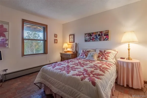 a bedroom with a bed and a lamp