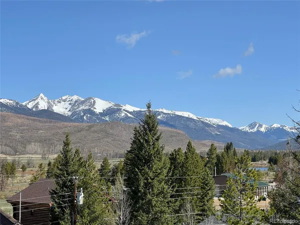 a view of a house with a mountain and a mountain in the background