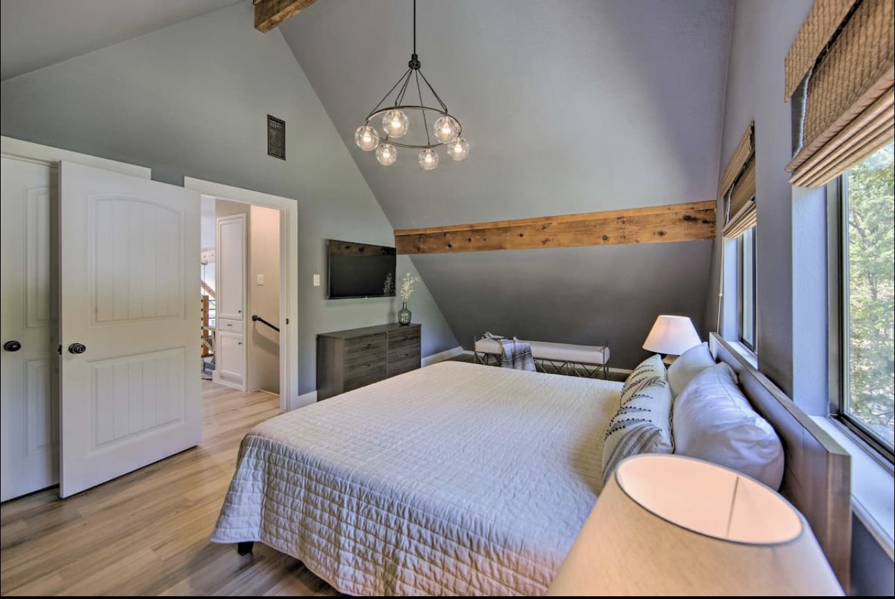 10630 River Ranch Road Kemp, TX 75143 - Photo 24 of 36 a bedroom with a bed and dresser with wooden floor