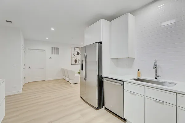 a kitchen with stainless steel appliances a refrigerator and cabinets