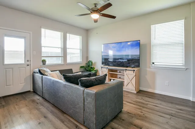 a living room with furniture and a flat screen tv