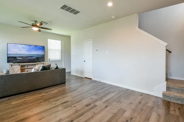 a view of room with furniture and wooden floor