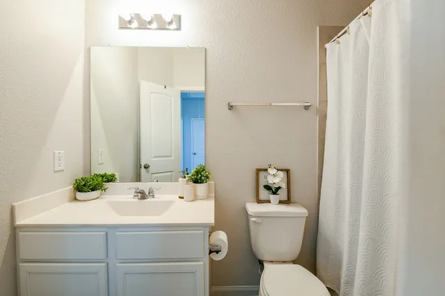 a bedroom with a bed and flat screen tv